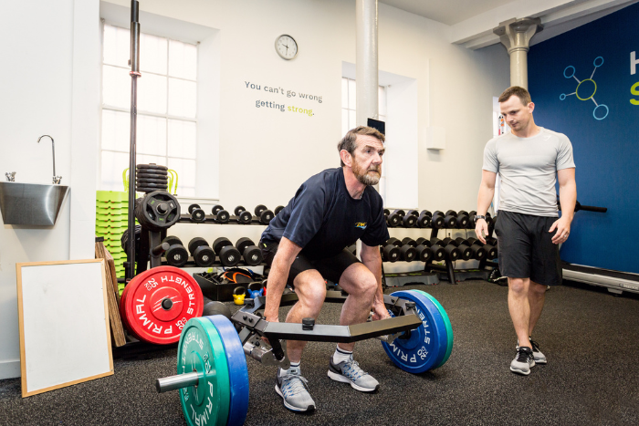 personal training client in edinburgh performing a deadlift.