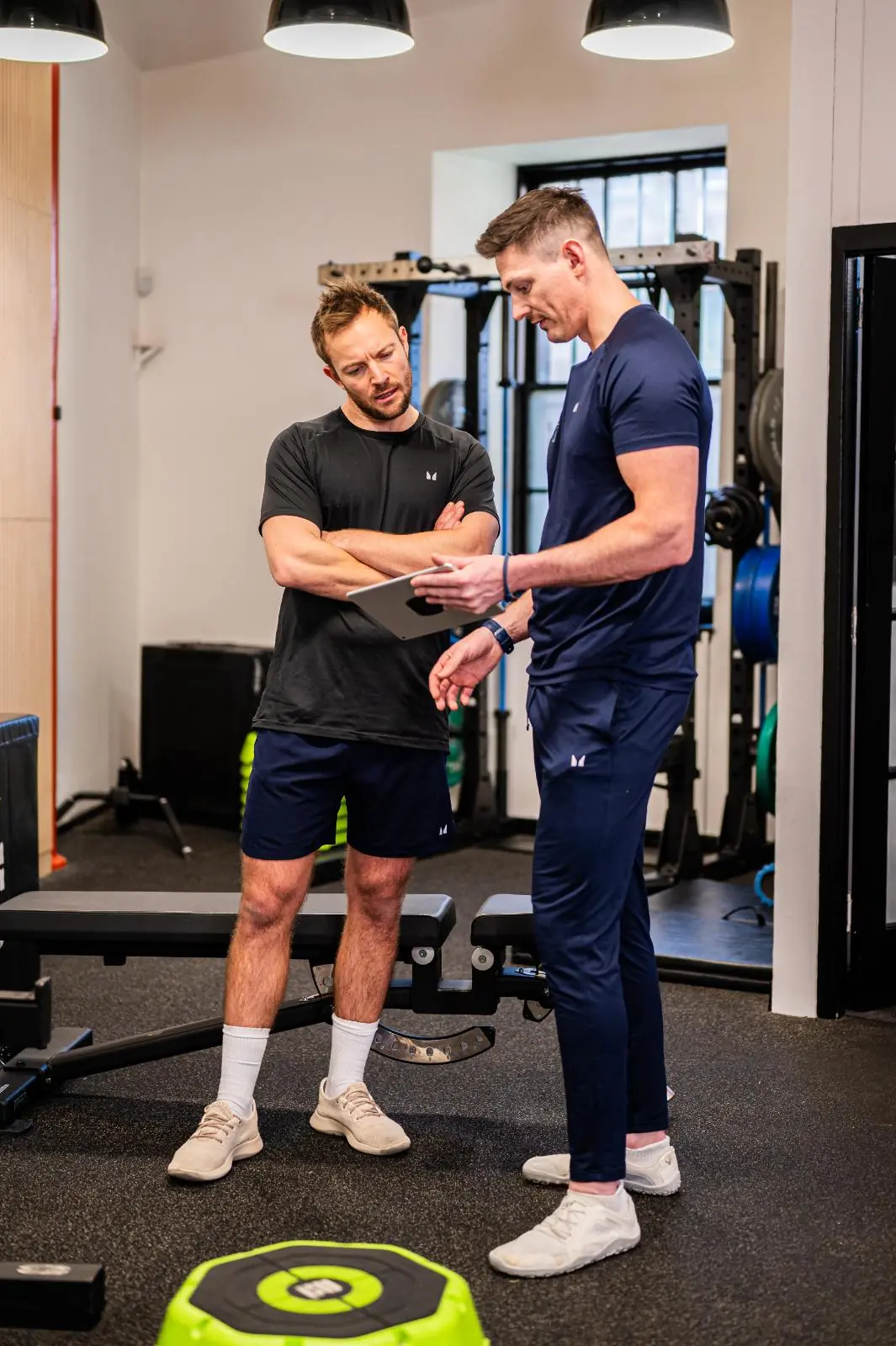 KA2_9255 Stuart and Ross reviewing patient biometrics for personal training Edinburgh and rehab progress in Leith.