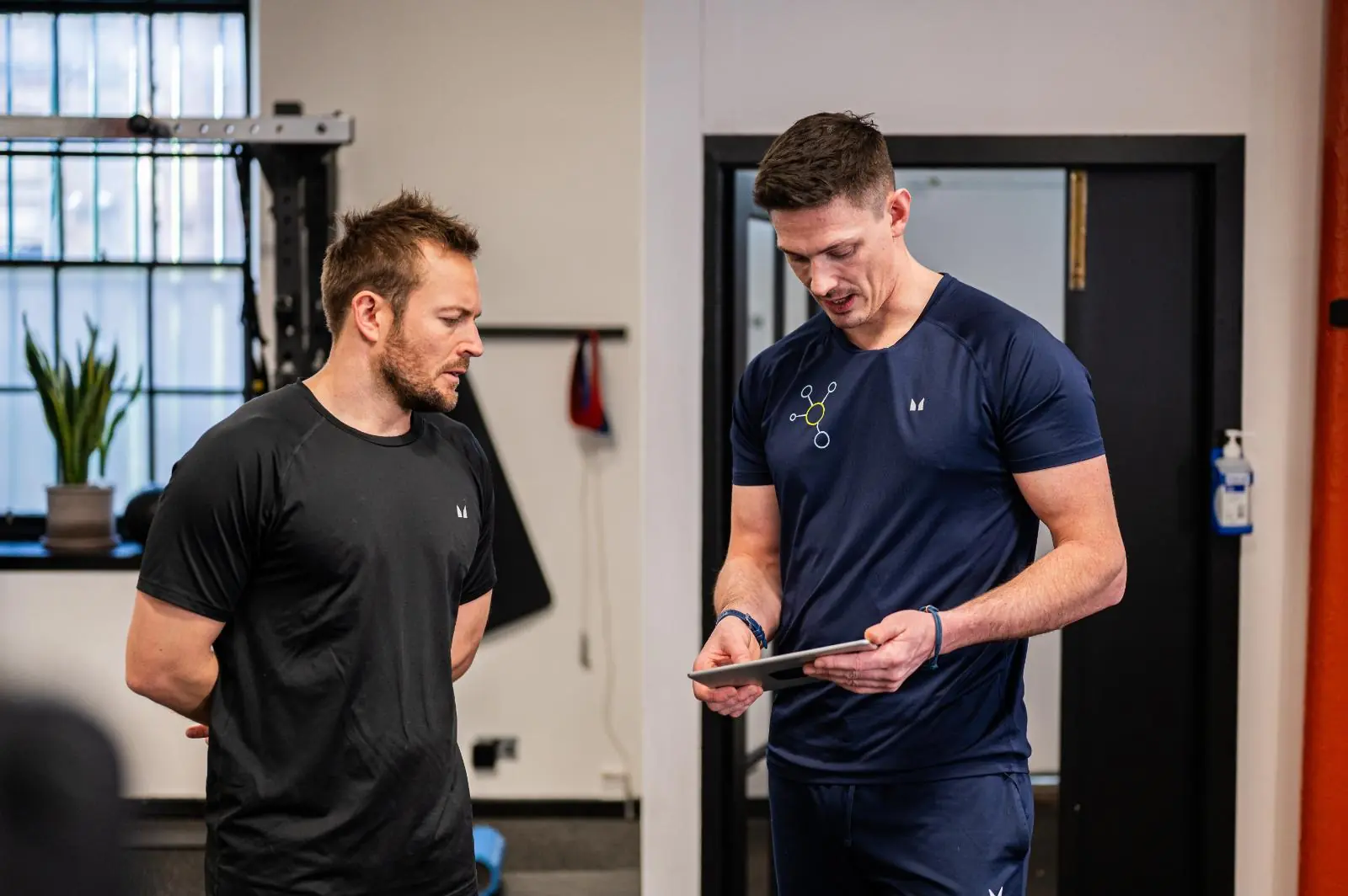 KA2_9297 Health by Science practitioners reviewing digital biometrics for personal training Edinburgh programs in Leith.