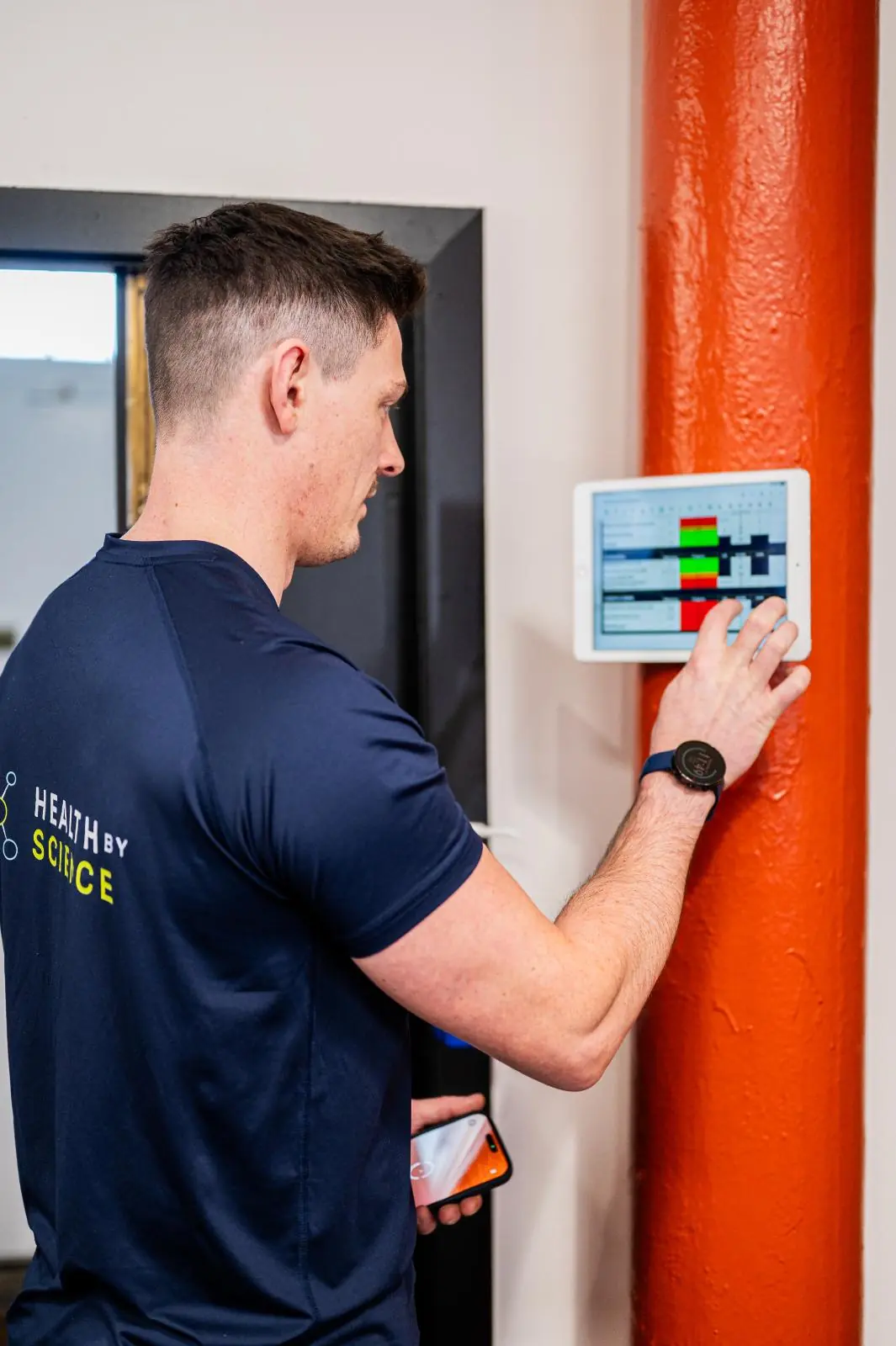 KA2_9317 Health by Science specialist updating a clinical performance dashboard during a personal training Edinburgh session in Leith.