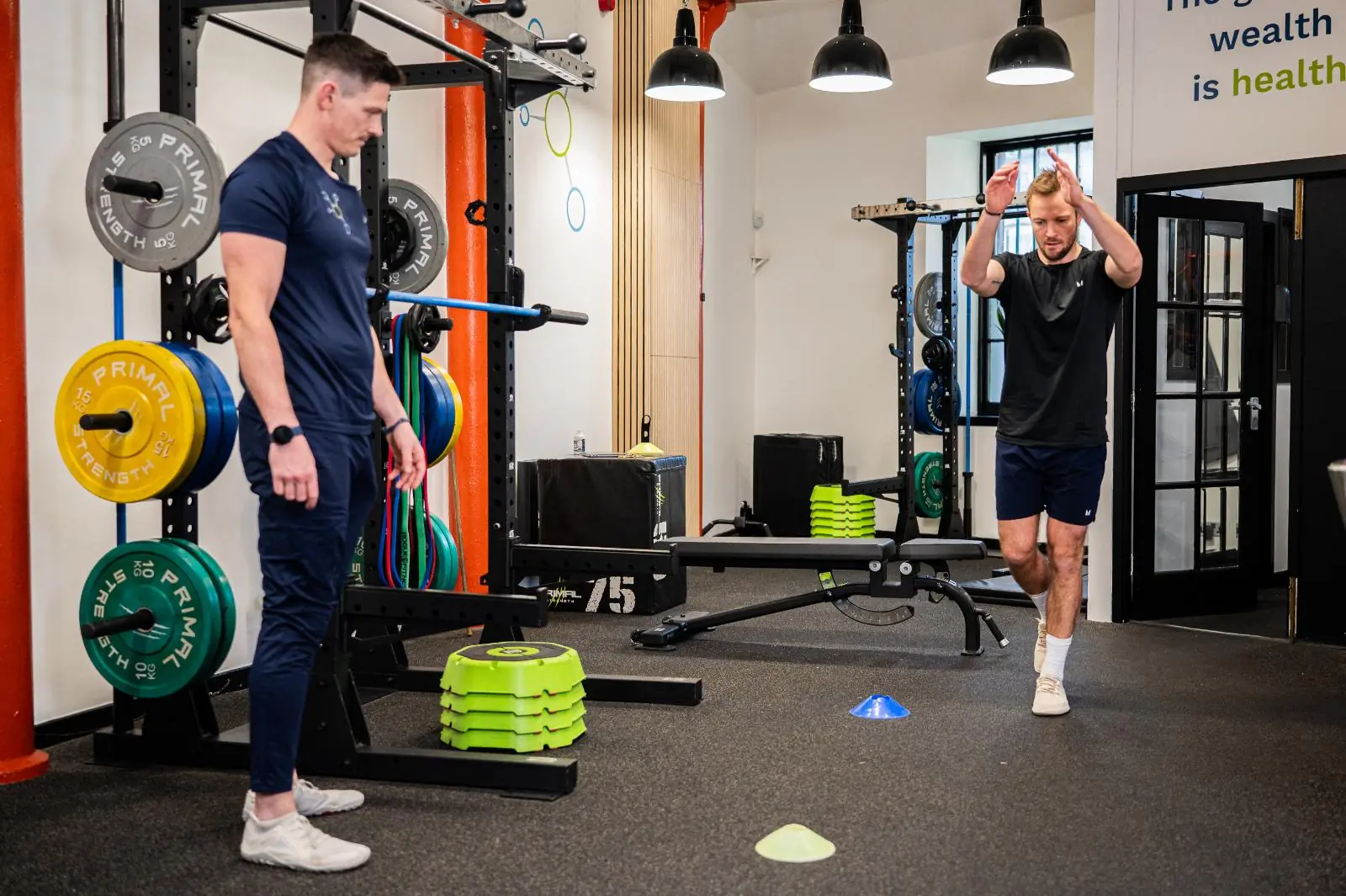 KA2_9334 Specialist conducting a biomechanical landing test to inform evidence-based small group personal training Edinburgh programmes in Leith.