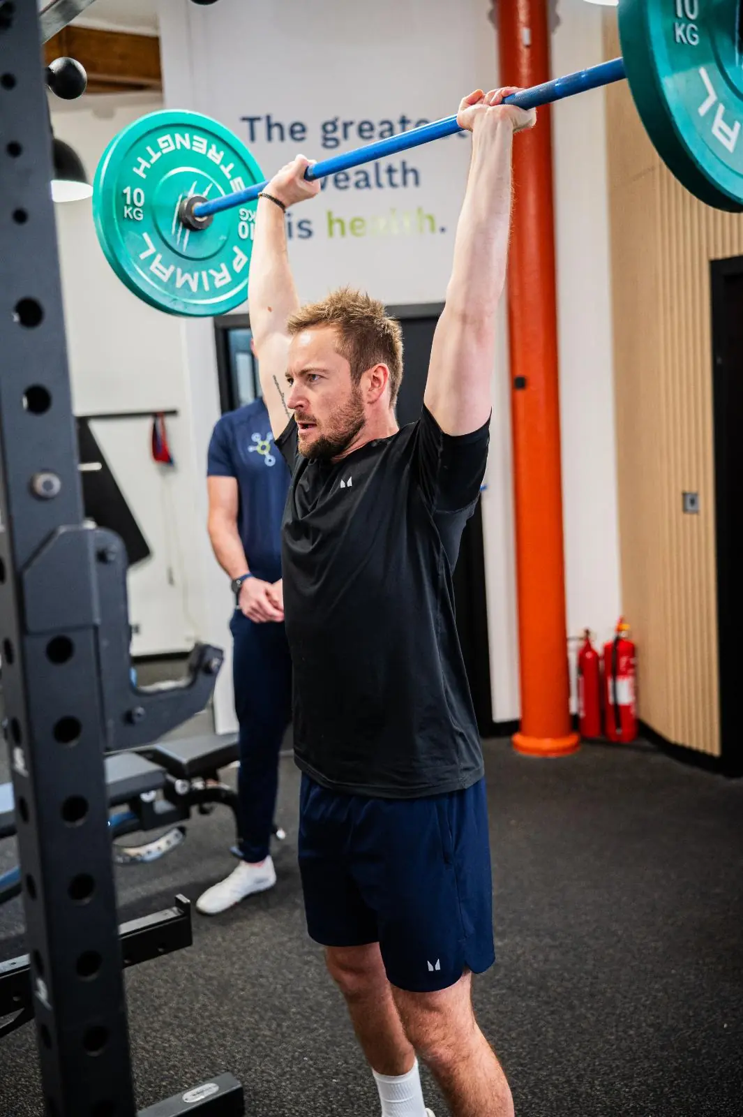 KA2_9494 Clinical supervision of a barbell overhead press to ensure joint safety during personal training Edinburgh in Leith.