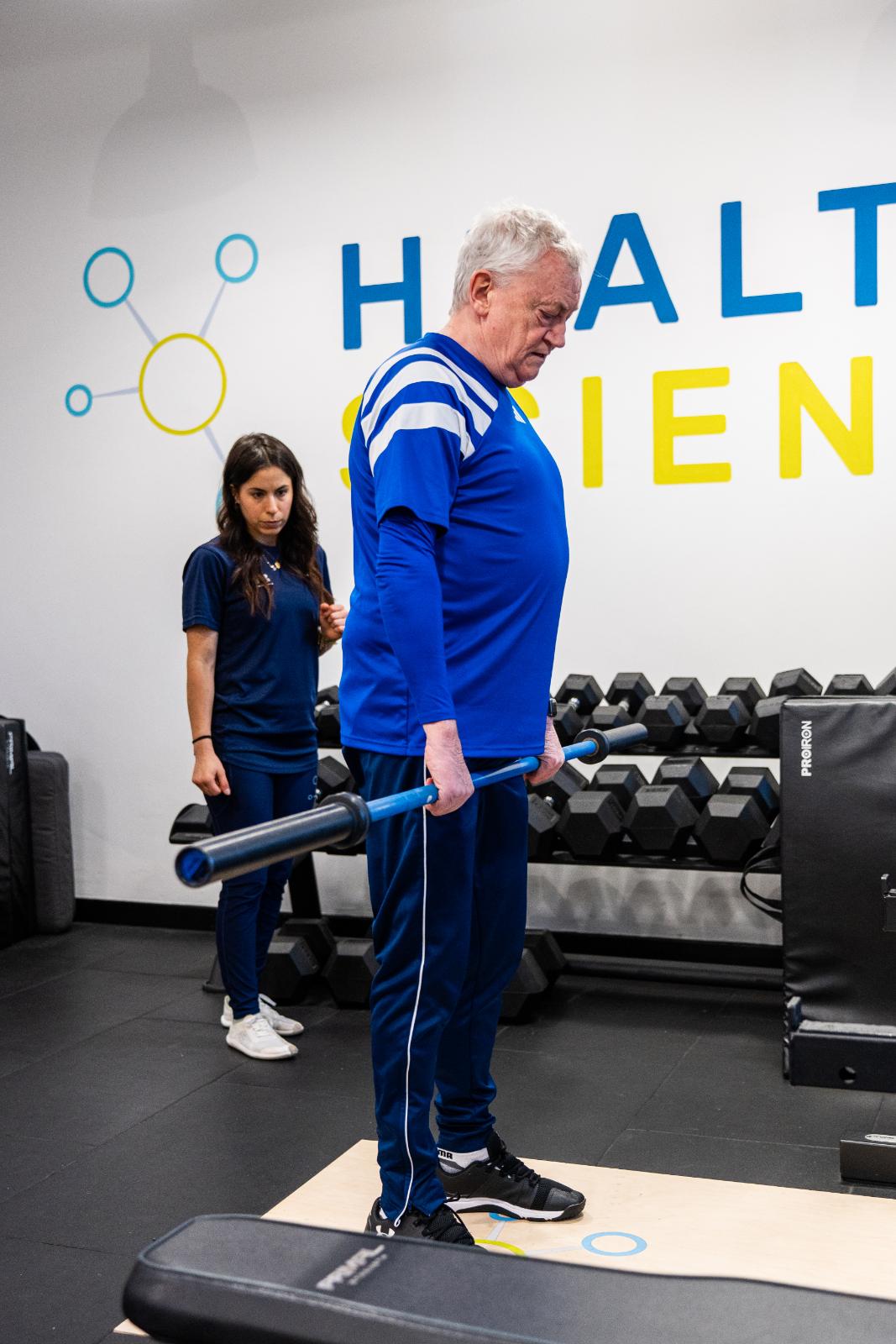 KA3_3096 Professional monitoring of a barbell deadlift setup to ensure lumbar safety for a personal training Edinburgh patient.