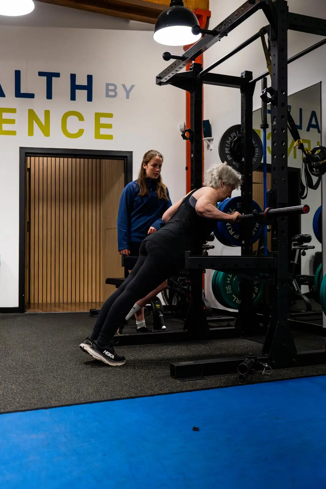 KA3_3498 Health by Science specialist monitoring an incline push-up progression for a senior patient to improve functional core strength.