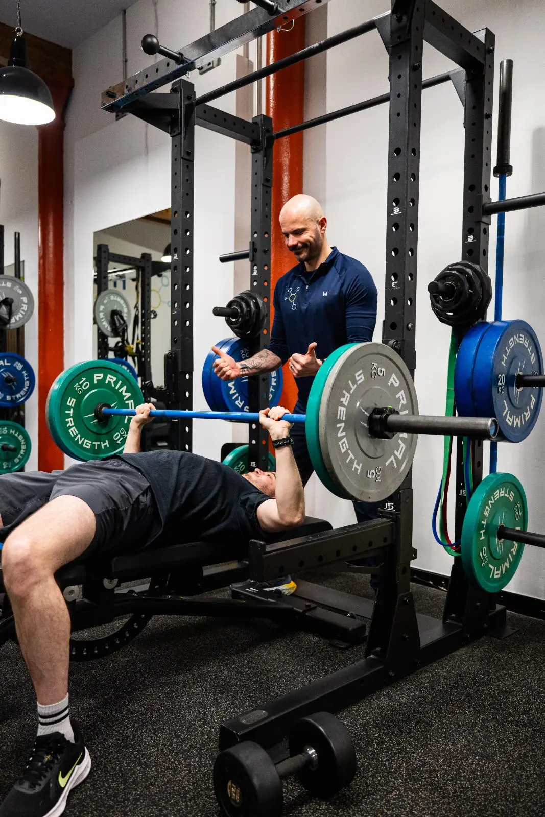KA3_3571 Strength Lab coach observing a member during a barbell bench press at Health by Science Leith, small group personal training Edinburgh.