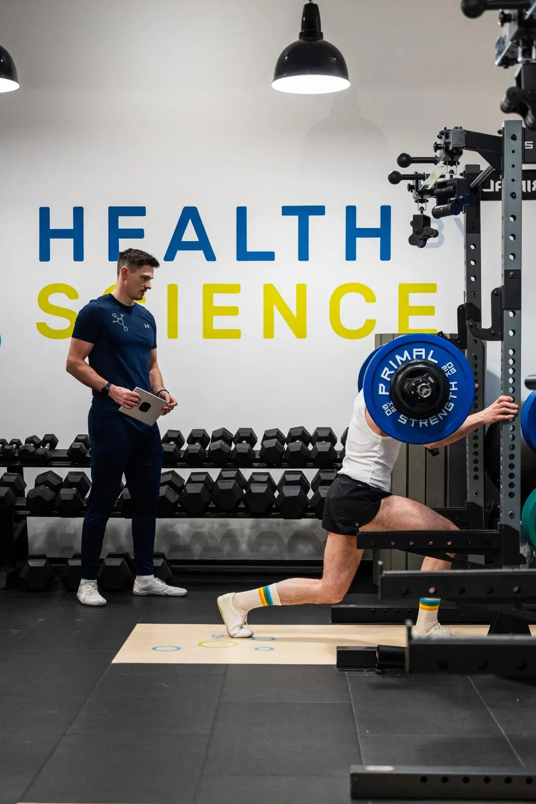 KA3_3695 Clinical assessment of a weighted lunge pattern conducted by a specialist at the Health by Science gym in Leith.