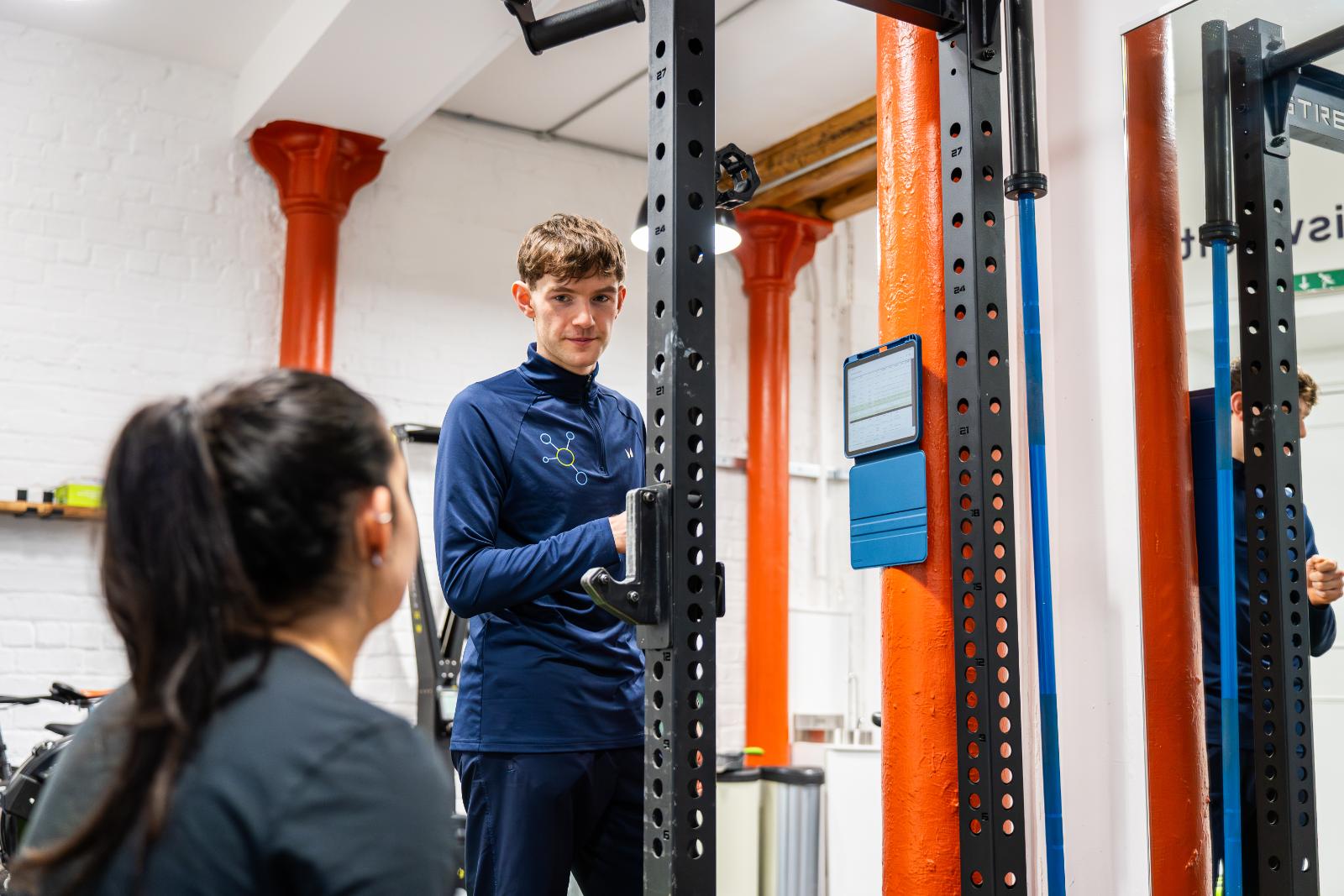 KA3_4046 Health by Science coach using a digital assessment tool to track biometric data and personal training progress for a client in Leith.