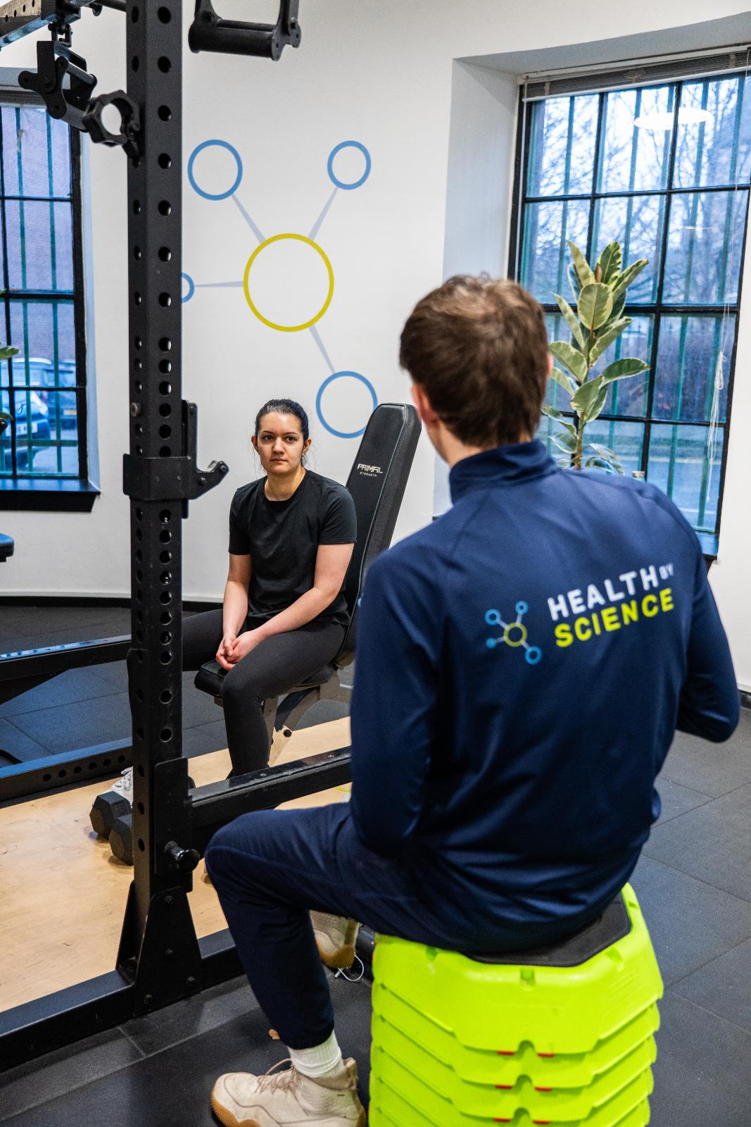 KA3_4075 Clinical movement consultation between a Health by Science specialist and a patient at our specialised Leith rehabilitation gym.