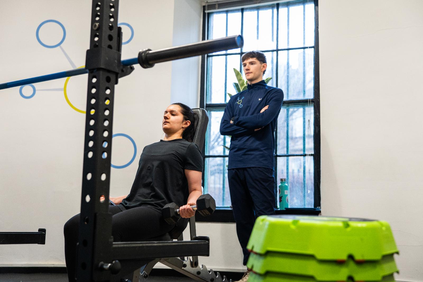 KA3_4155 Clinical personal training session in Leith, featuring a seated dumbbell curl to assess upper body muscular endurance and form.