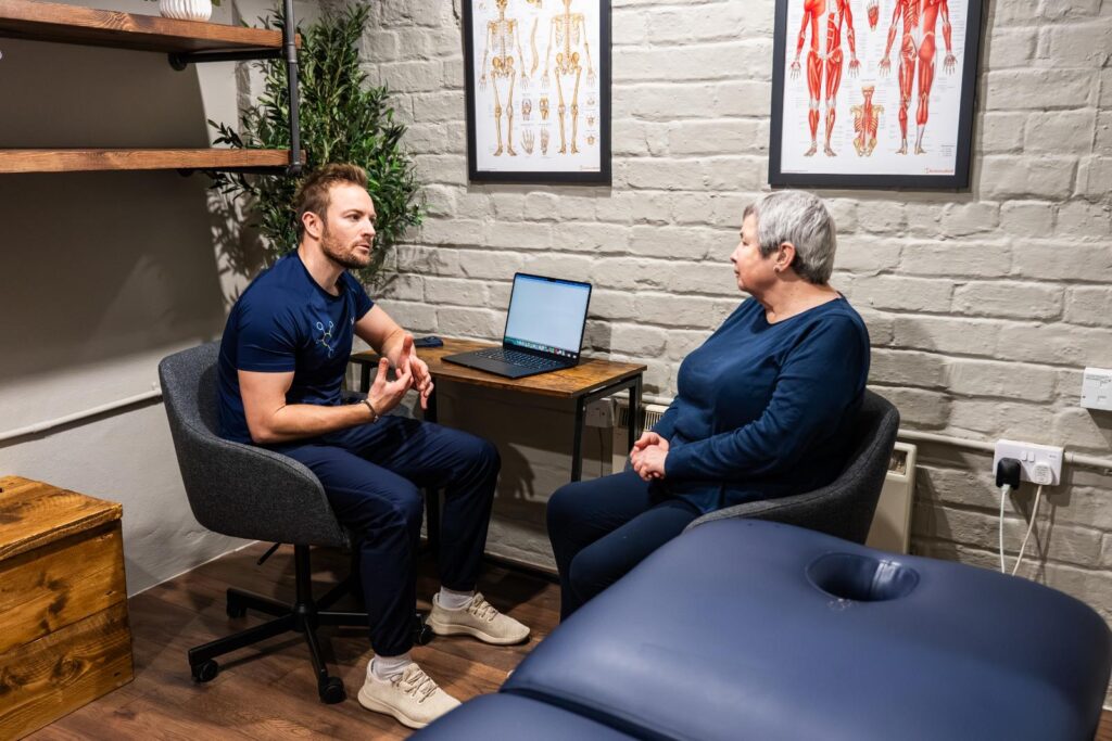 Health by Science practitioner providing expert advice during a clinical intake and assessment session for a new patient in Leith.
