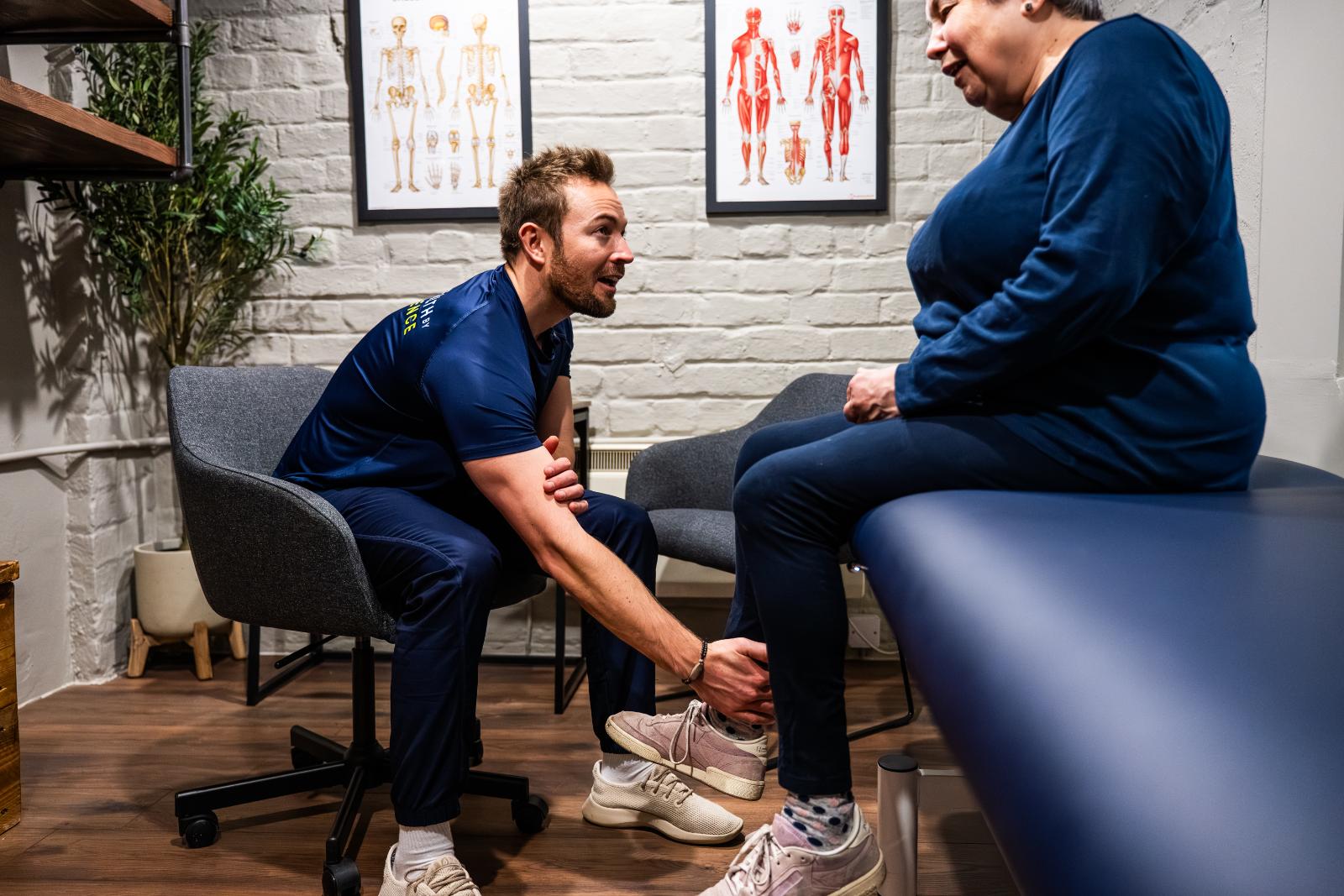 Health by Science specialist performing a manual clinical assessment of ankle mobility and lower leg alignment in Leith.