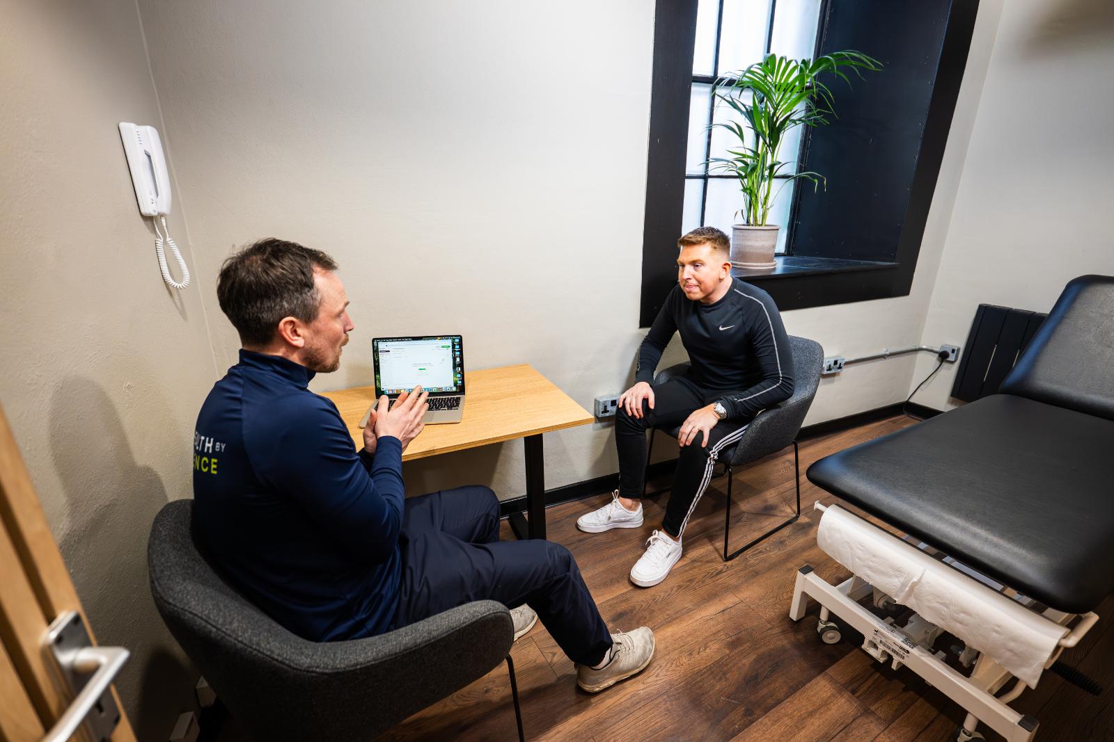 Professional practitioner conducting a private clinical consultation with a patient in our dedicated Leith treatment room.
