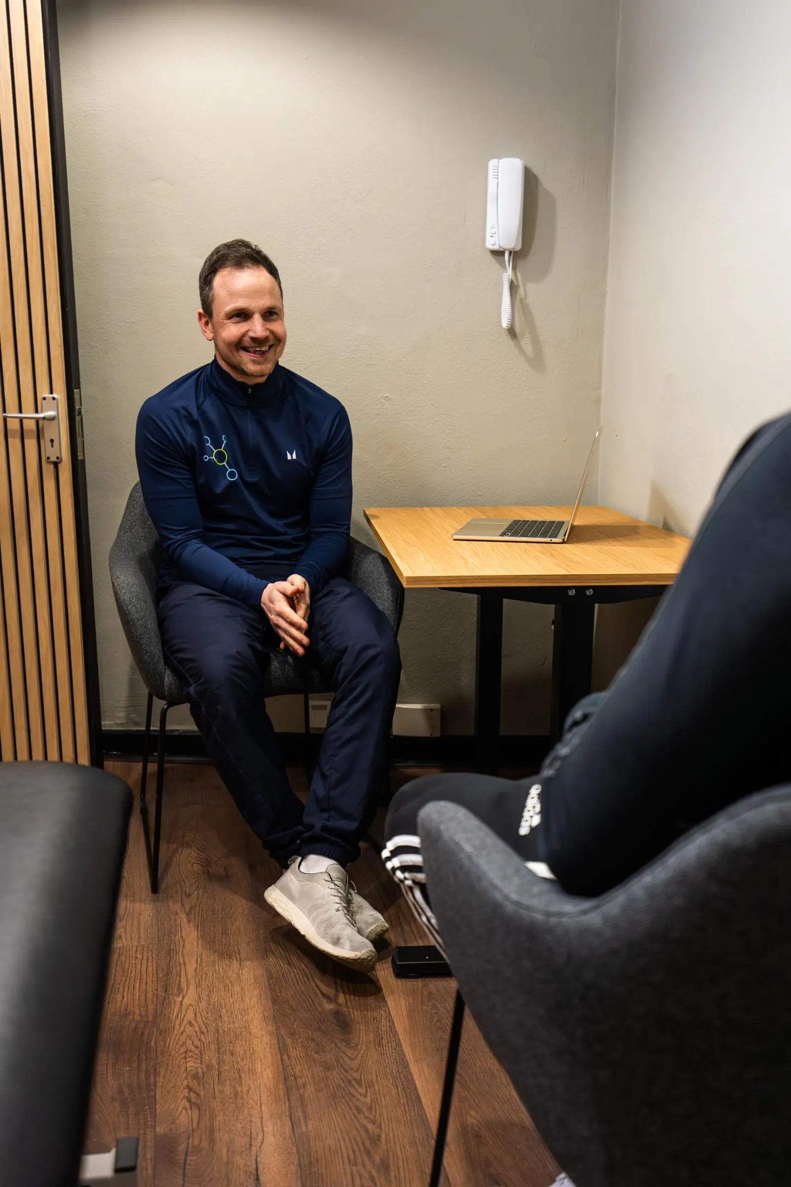 KA3_4617 Specialist providing empathetic clinical advice and reviewing digital progress records with a patient in our Leith facility.