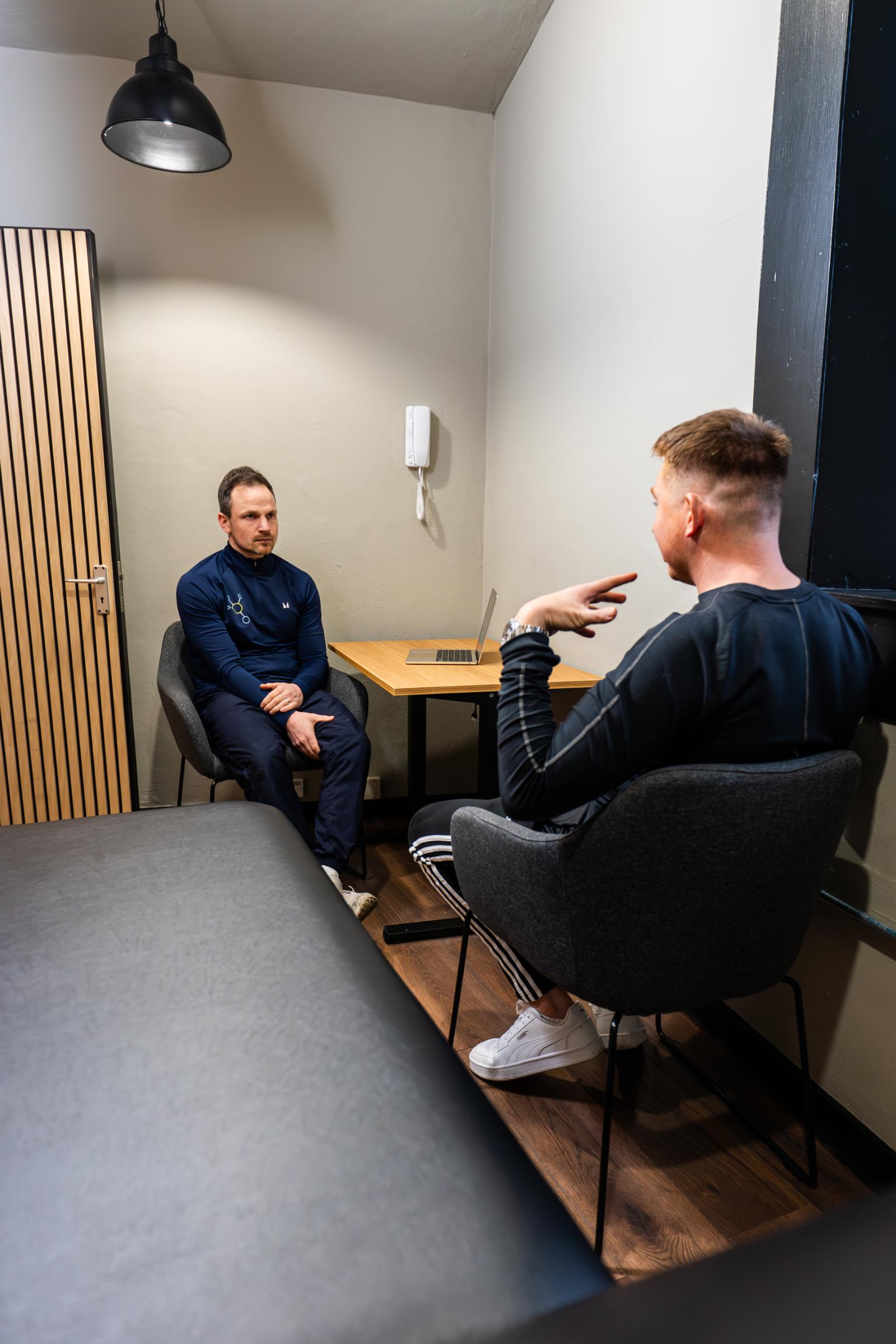 KA3_4627 Focused patient intake and clinical assessment session within the professional treatment room at Health by Science Leith.