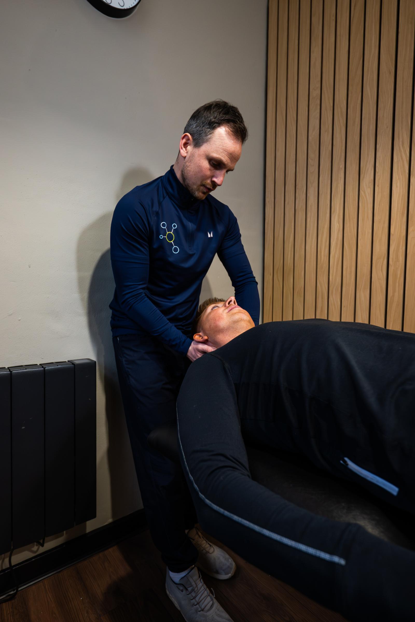 KA3_4664 Health by Science specialist performing a clinical manual therapy assessment of a patient's neck and cervical spine in Leith.