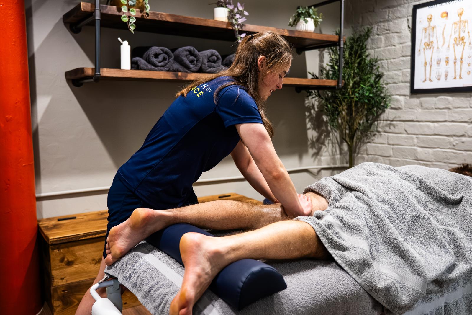 Sports massage therapist treating a client's upper back at Health by Science, Leith, Edinburgh