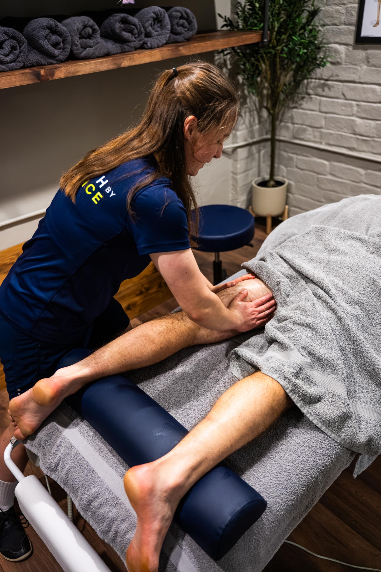 Sports massage therapist treating a client's upper back at Health by Science, Leith, Edinburgh